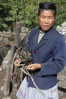 A Miao woman carrying tools